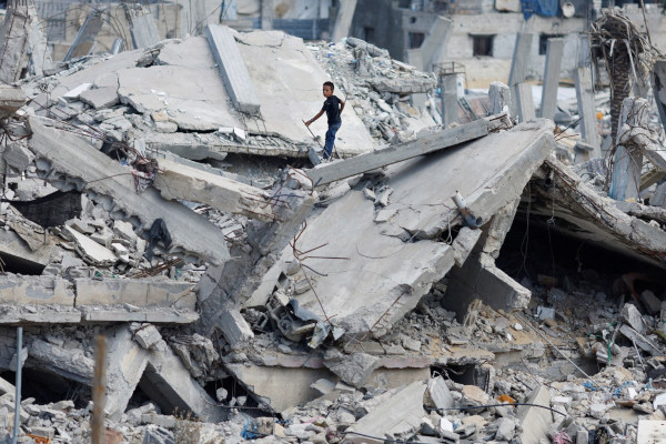 Child searching through rubble